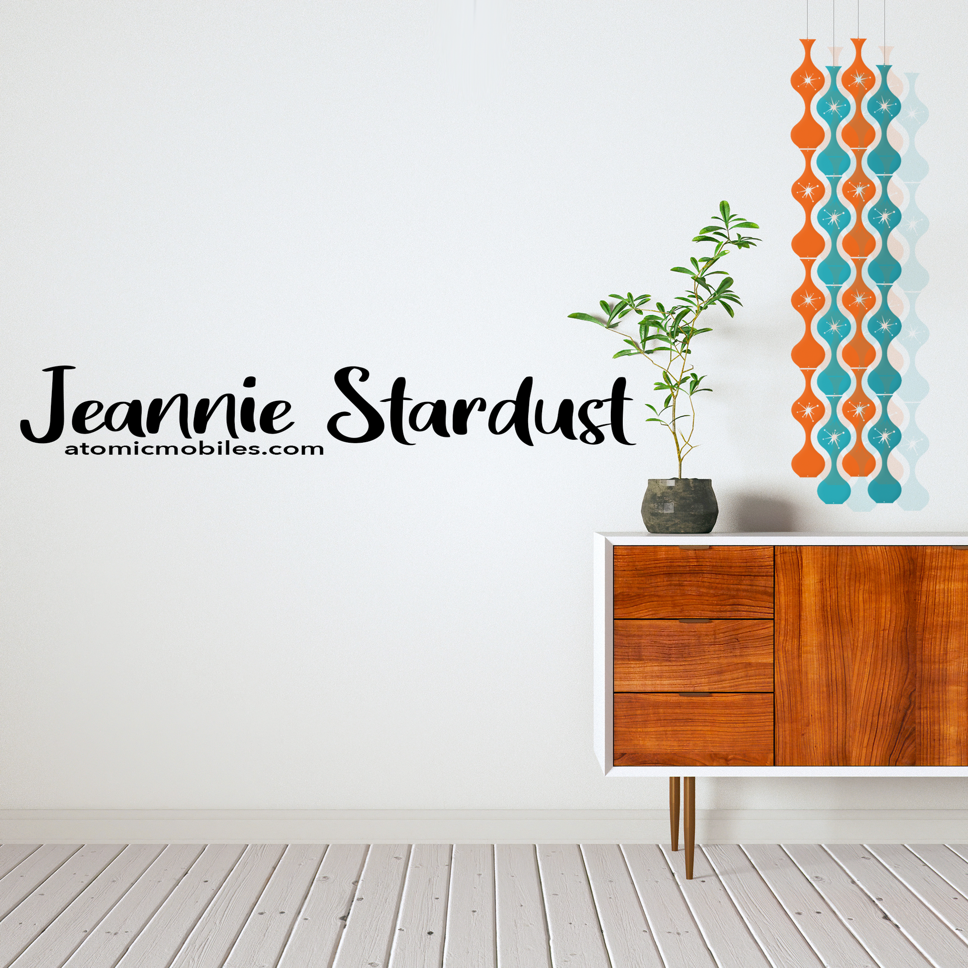 Beautiful Jeannie Stardust kinetic hanging art mobile in transparent Orange and Teal  with MCM wood credenza and bamboo plant - mid century modern style art mobiles by AtomicMobiles.com