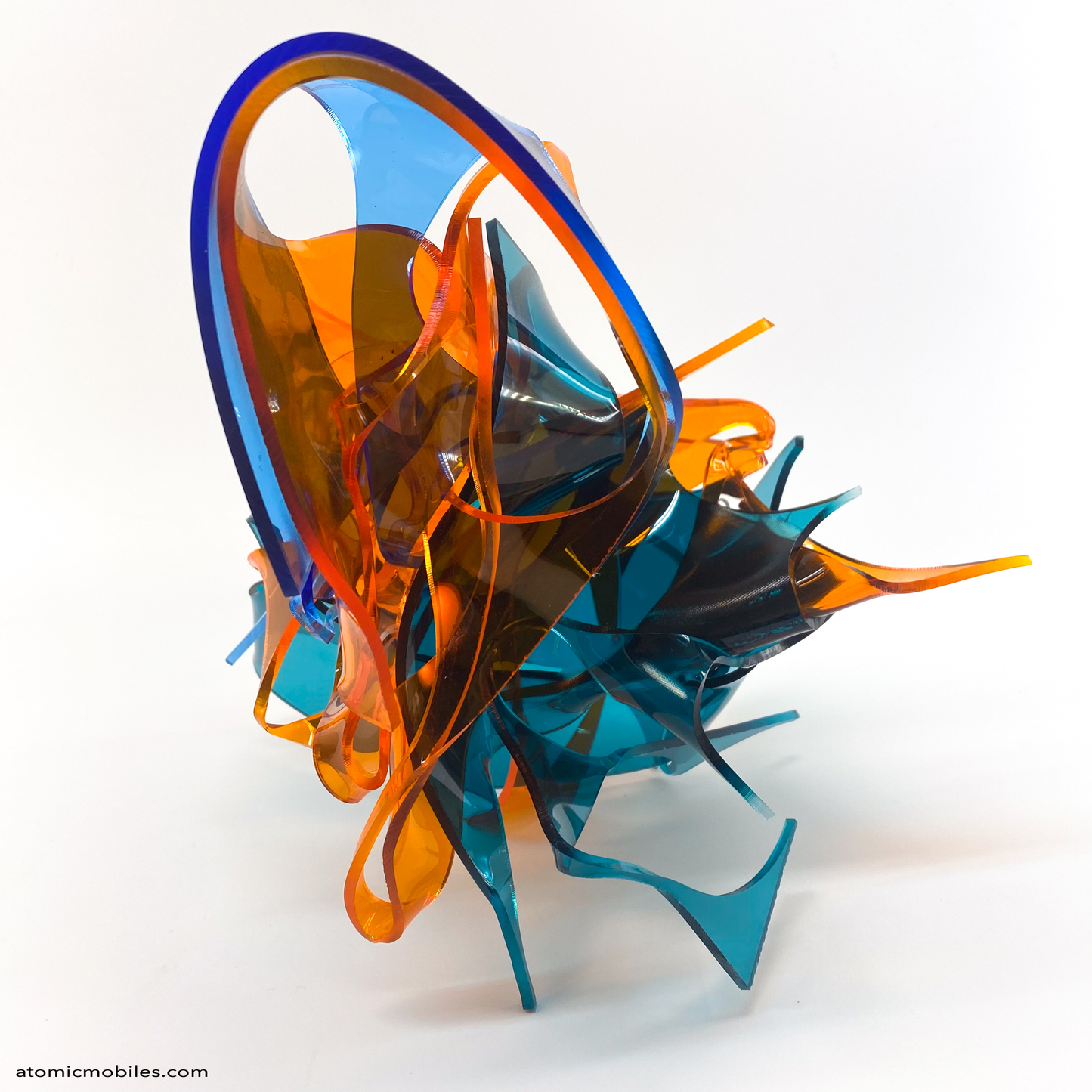 back view of Colorful abstract sculpture in transparent orange, teal, and blue plexiglass acrylic on a white background titled Radiance of Water - one of a kind art by Debra Ann of Atomic Mobiles