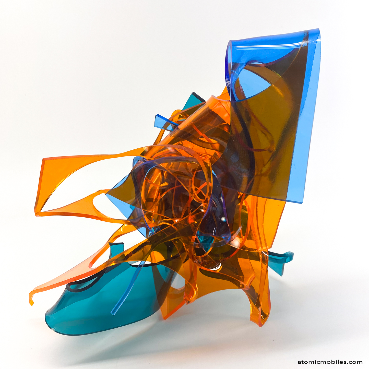 another view of Colorful abstract sculpture in transparent orange, teal, and blue plexiglass acrylic on a white background titled Radiance of Water - one of a kind art by Debra Ann of Atomic Mobiles