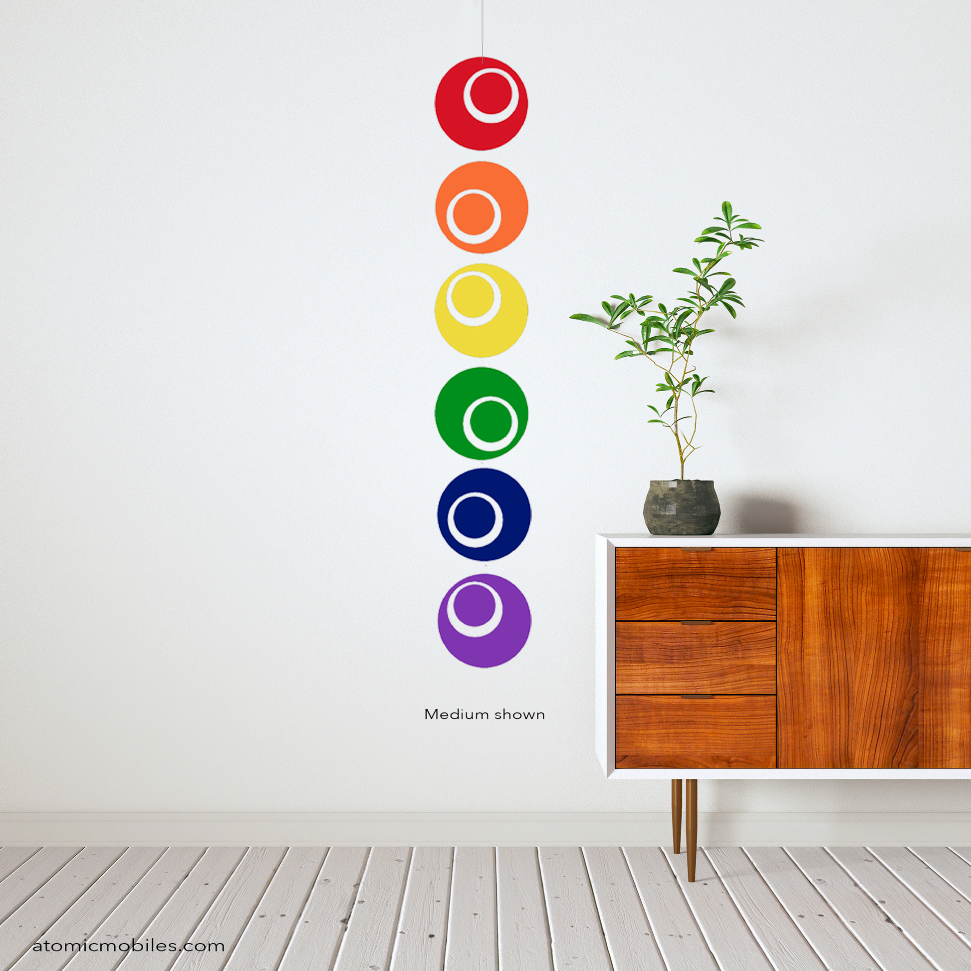 Modern credenza with plant and LGBTQ+ GAY PRIDE Rainbow Hanging Vertical Art Mobile by AtomicMobiles.com