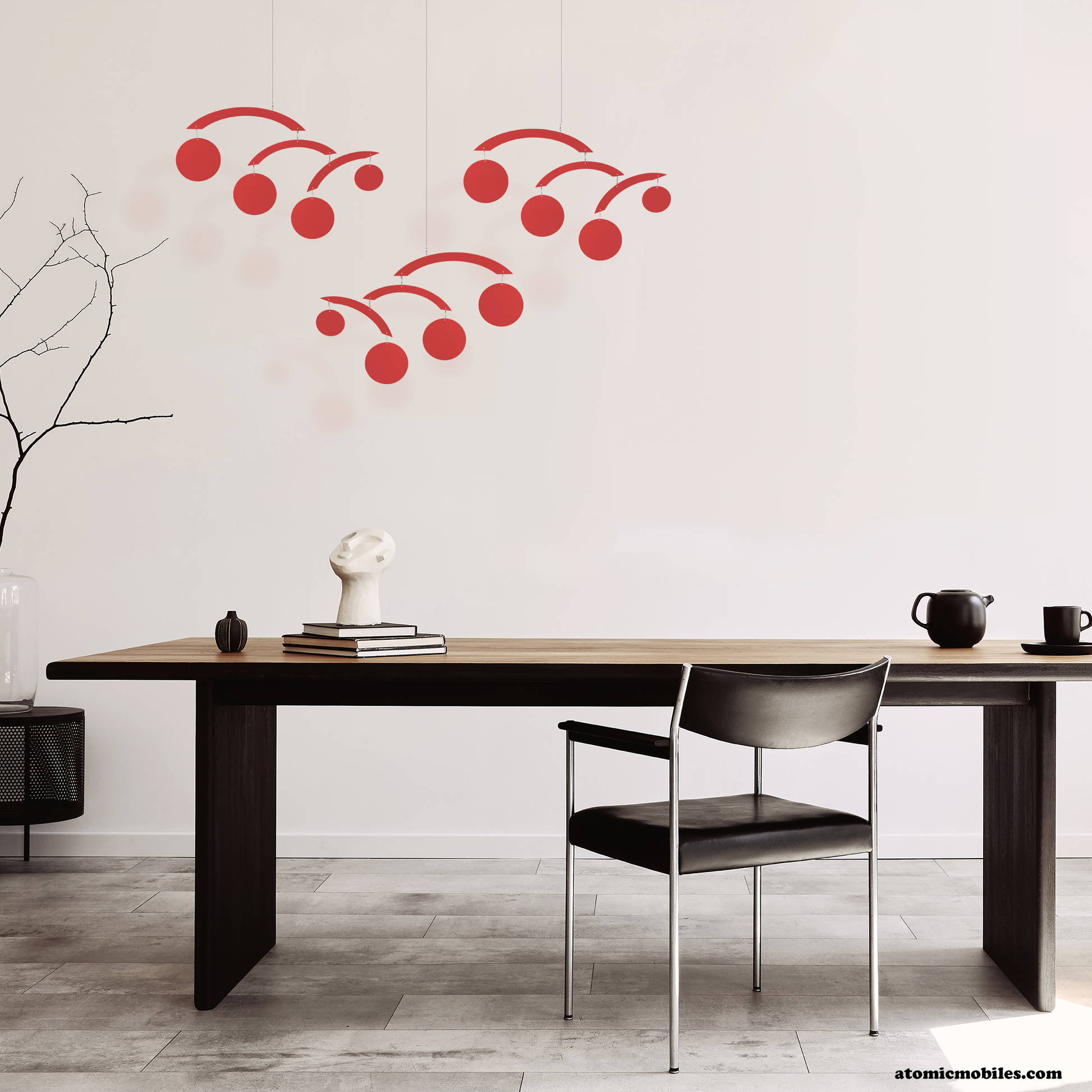 3 transparent red acrylic modern hanging art mobiles by Atomic Mobiles in contemporary dining room with wood table 