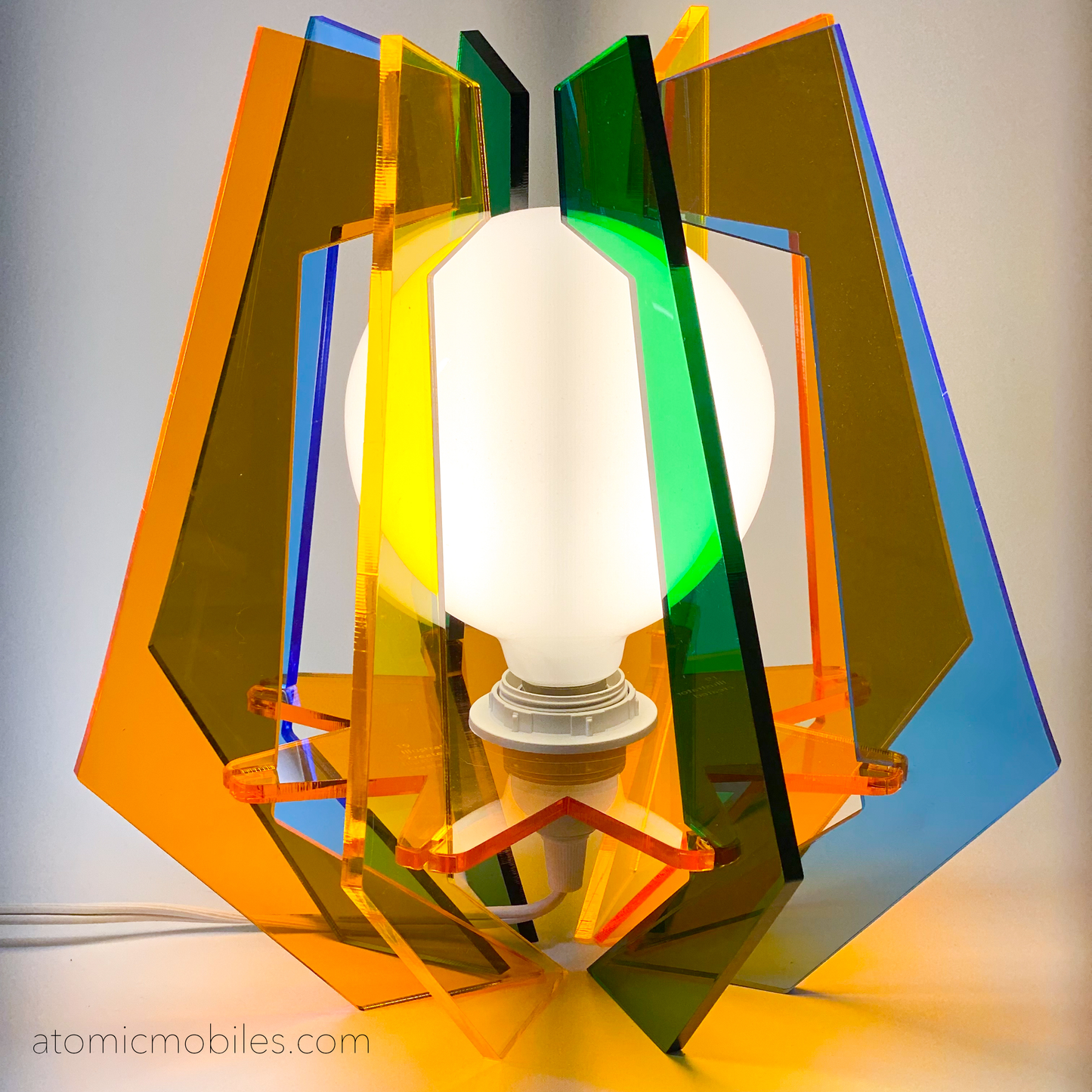 Lit up 1971 Space Age Lamp in clear acrylic colors of orange, blue, yellow, and green- retro mid century modern groovy lighting by AtomicMobiles.com
