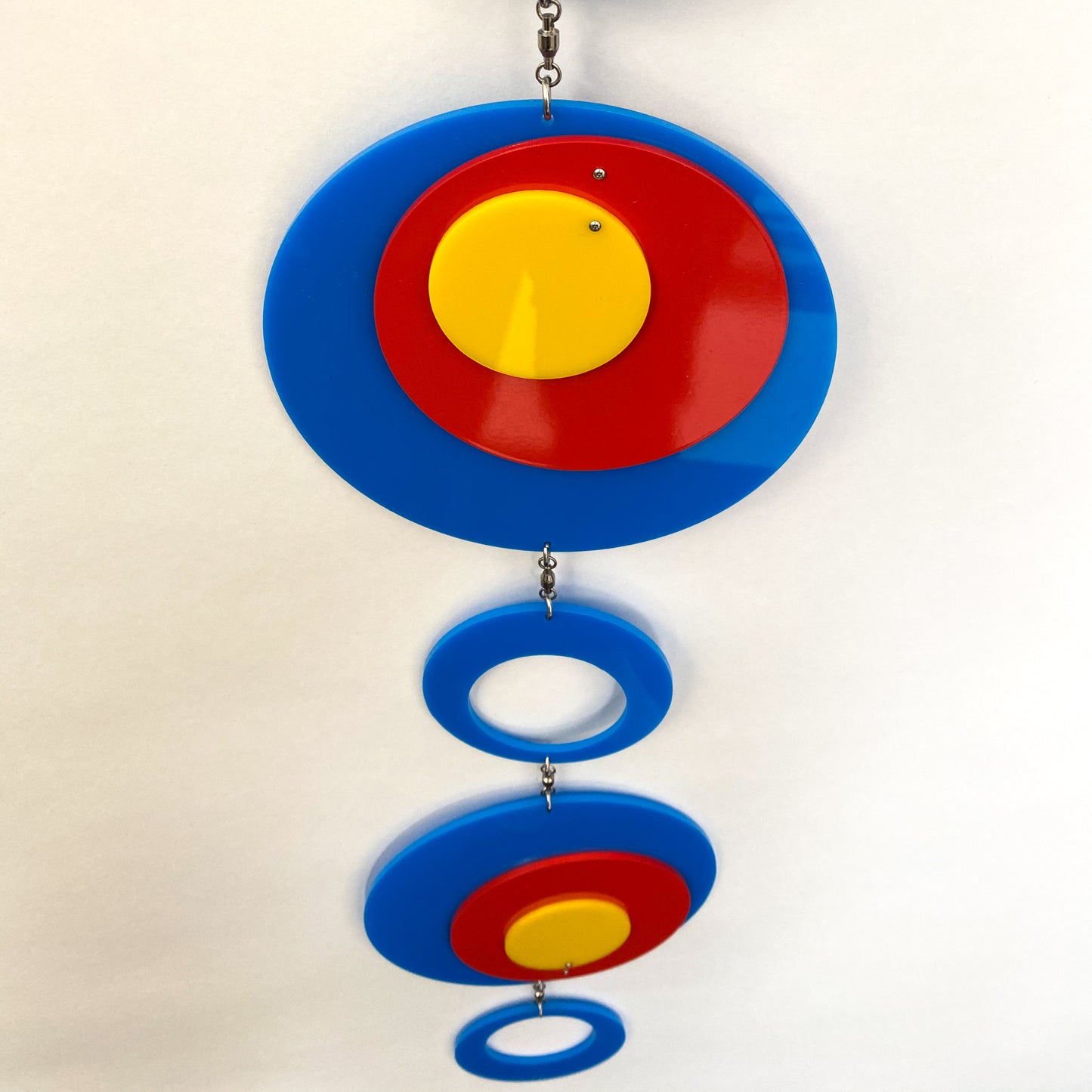 Another view of Groovy Twirly Blue Multi Color Vertical Kinetic Mobile in Blue Red and Yellow by AtomicMobiles.com