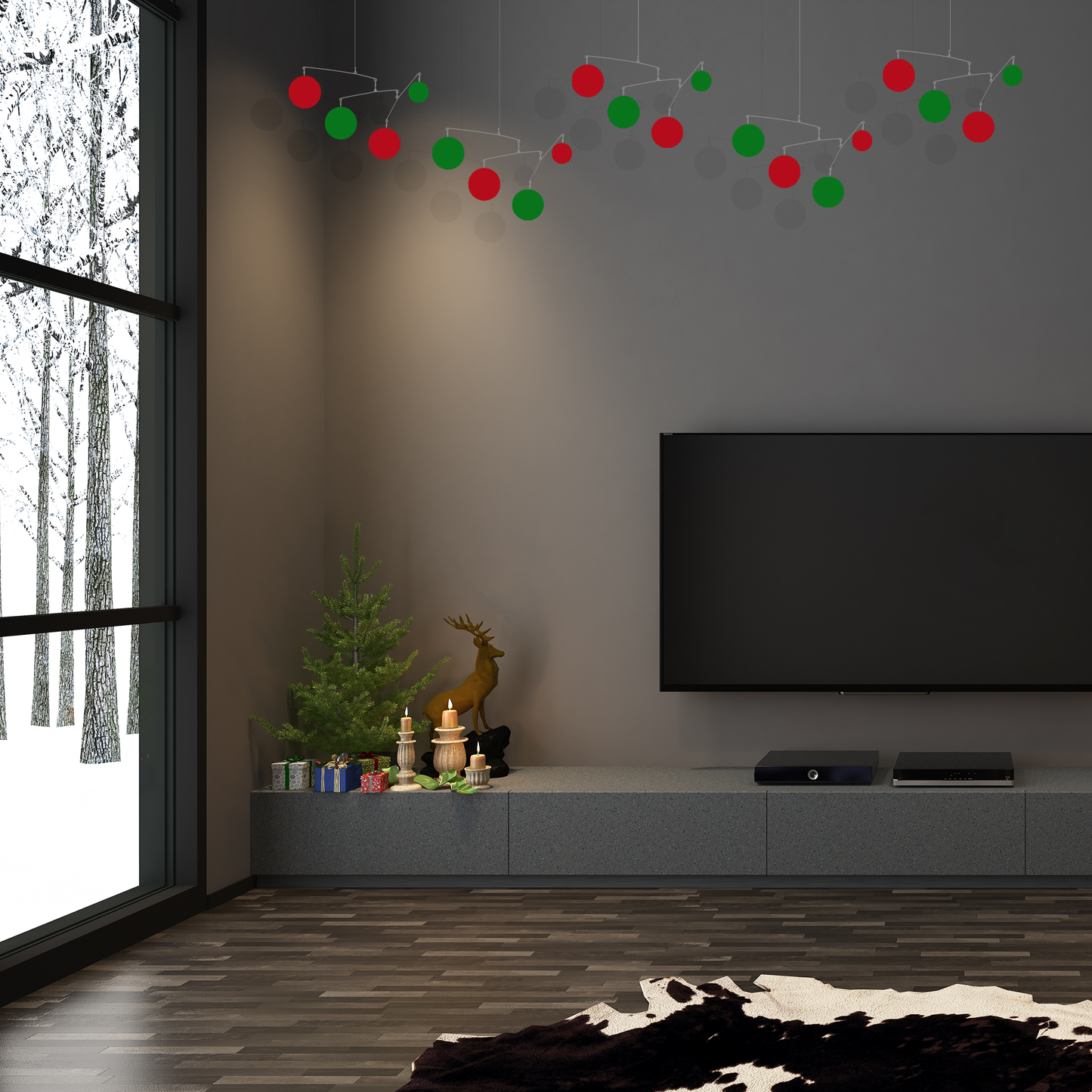4 beautiful red and green hanging art mobiles in dark gray room with Christmas decorations and large TV with snow outside - mobiles by AtomicMobiles.com