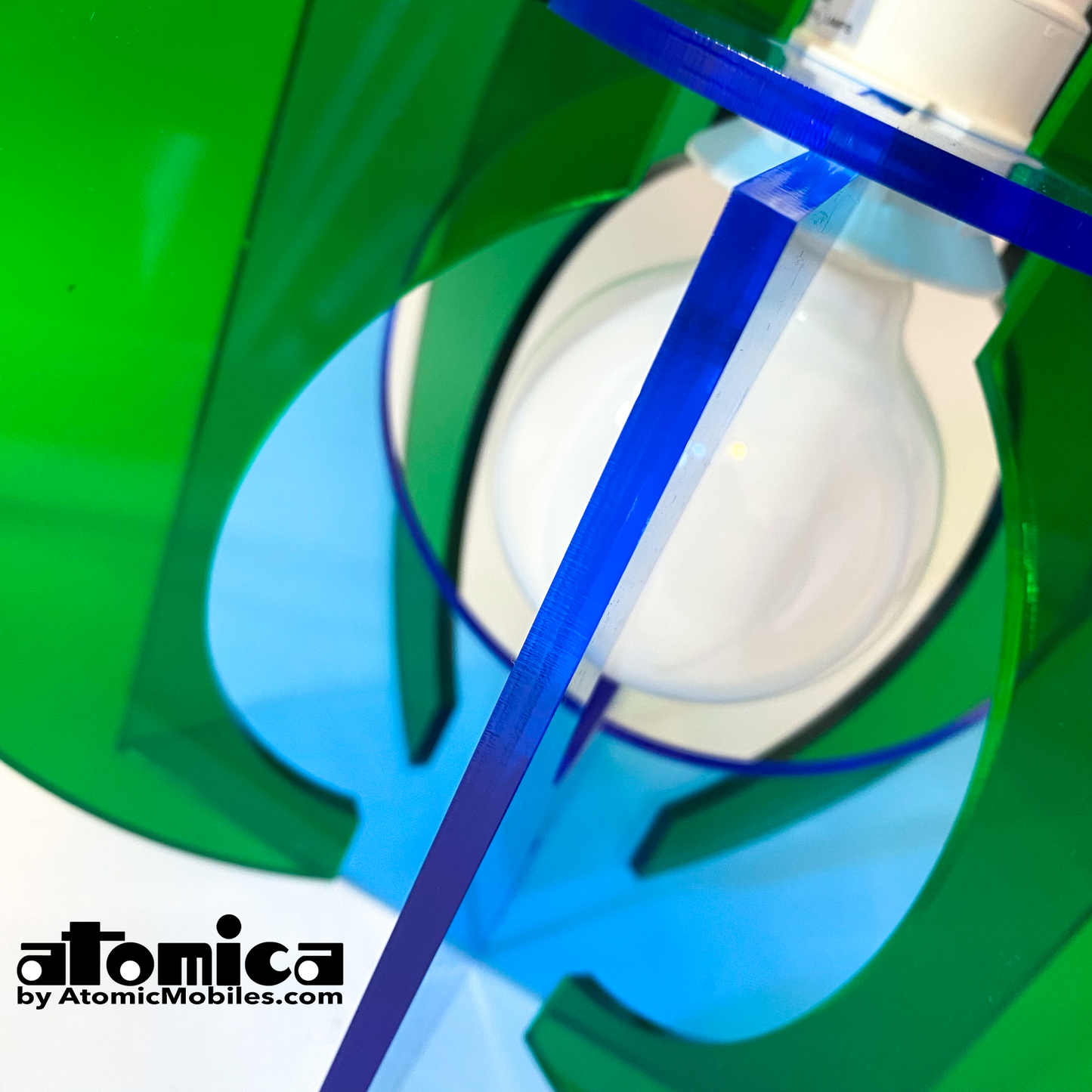Closeup of Atomica Space Age Lamp in clear blue and green plexiglass acrylic by AtomicMobiles.com