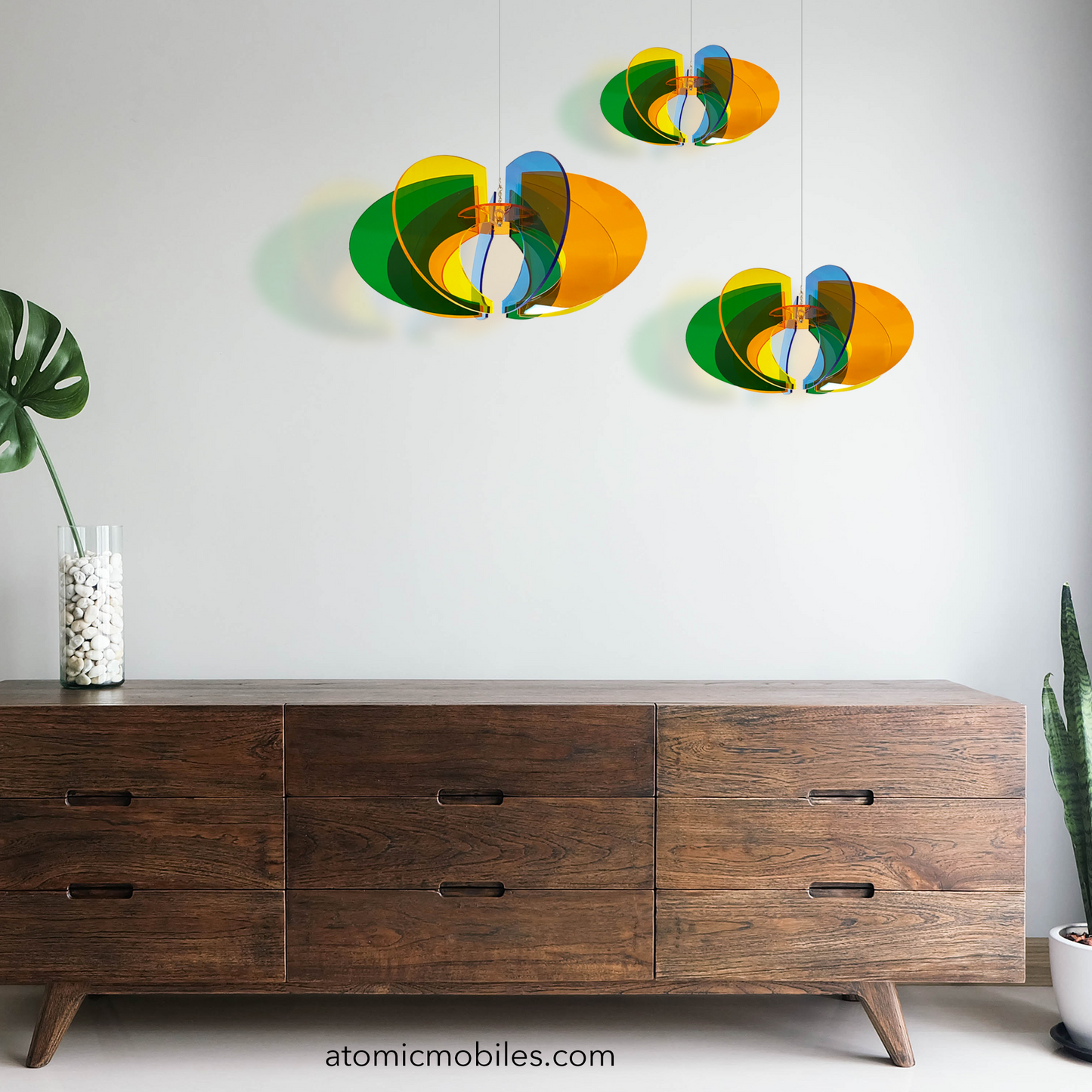 Beautiful grouping of 3 Space Age Orbit  RotaMobiles in 3 sizes with wood credenza and plants - hanging rotating art mobiles by AtomicMobiles.com