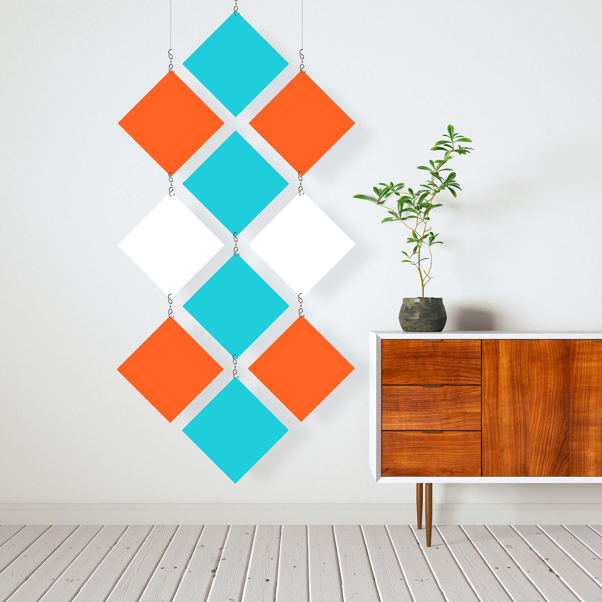 Mid Century Modern Hanging Kinetic Room Divider and Mobile in Orange, Aqua, and White  next to modern wood credenze sideboard with plant in white room - MODcast colorful room divider mobiles by AtomicMobiles.com