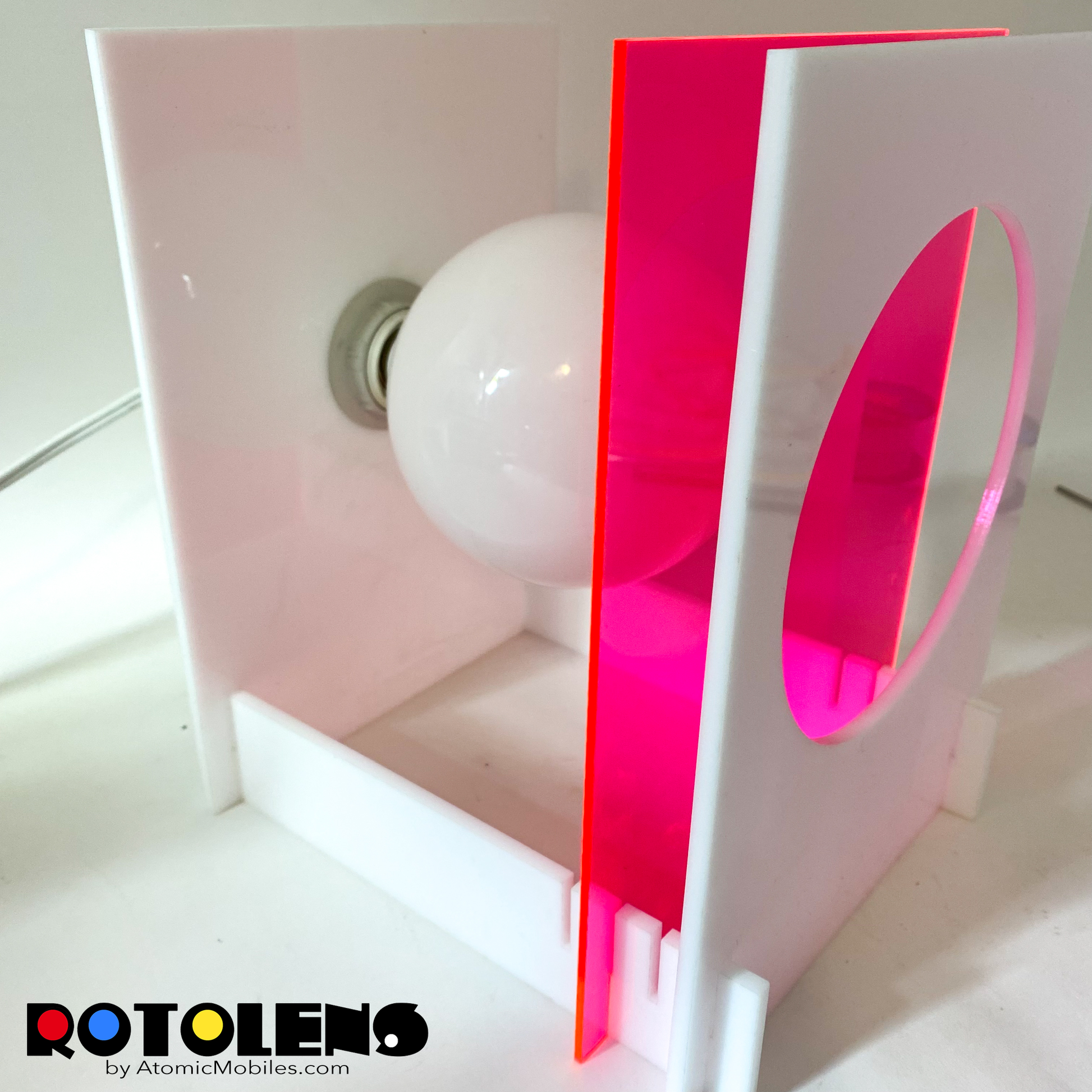 Side view of ROTOLENS Space Age Lamp with interchangeable clear plexiglass lens in Fluorescent Hot Pink by AtomicMobiles.com