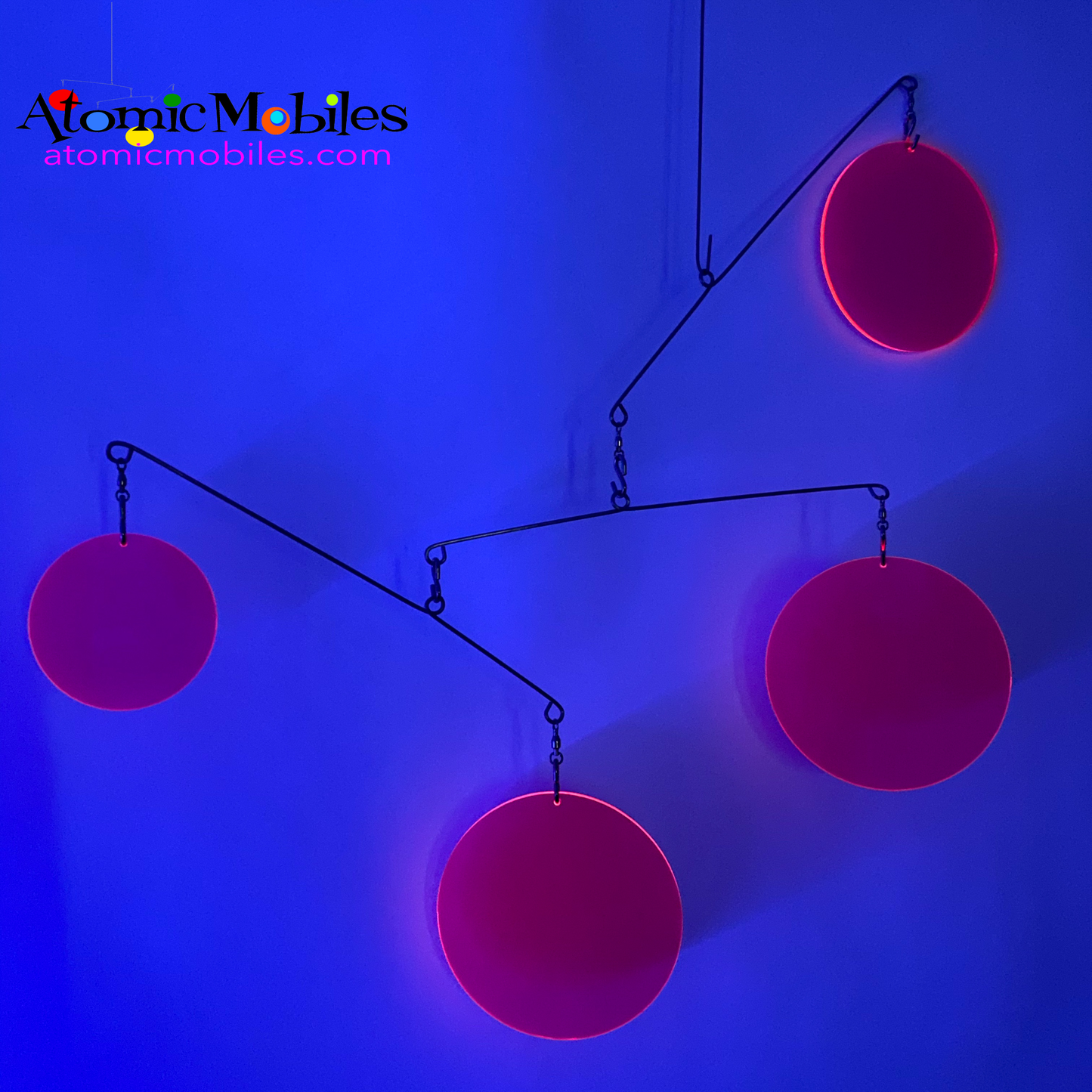 Neon Fluorescent Hot Pink Atomic Mobile under black light -  hanging modern kinetic art mobiles by AtomicMobiles.com