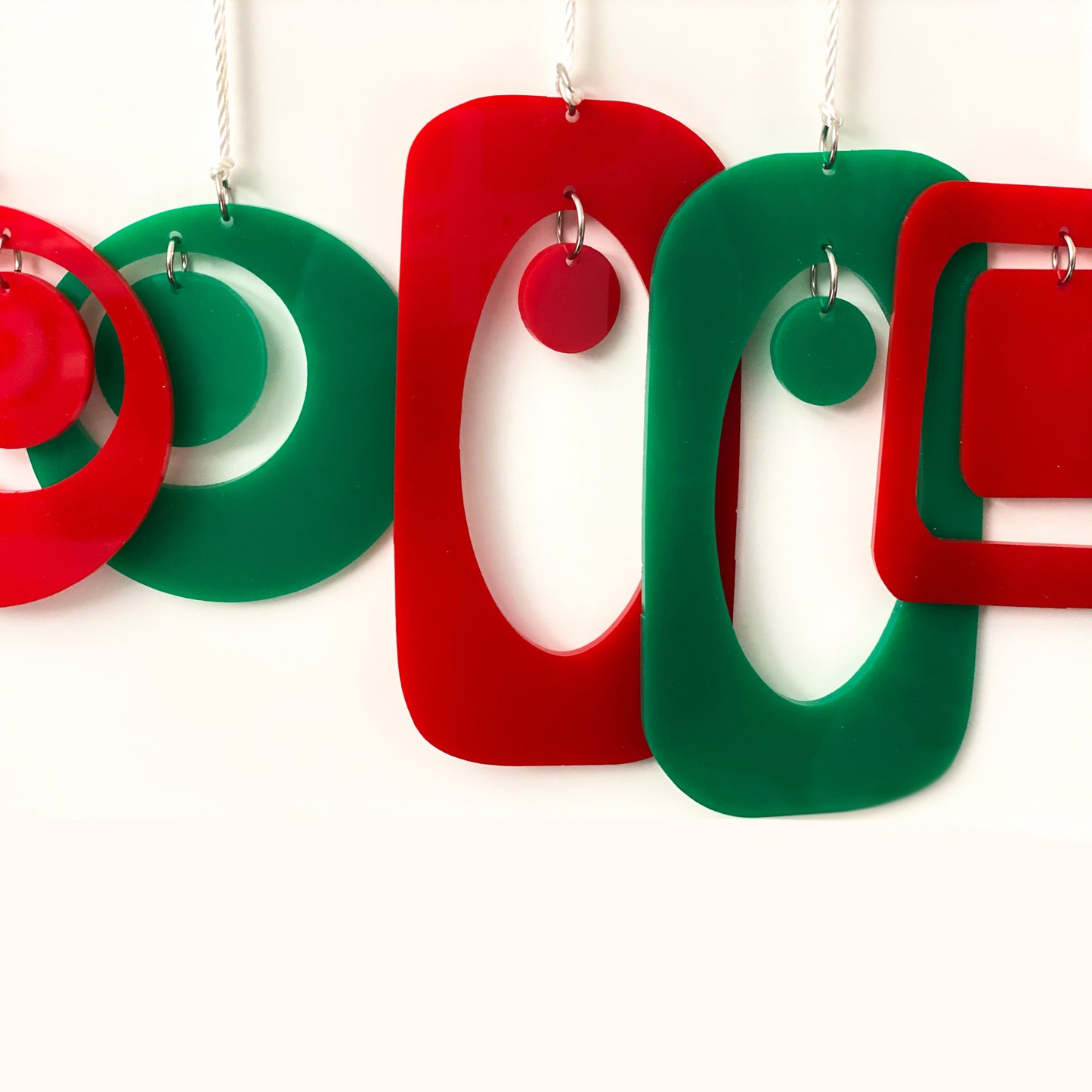 Closeup of mid century modern style Christmas Ornaments in red and green by AtomicMobiles.com