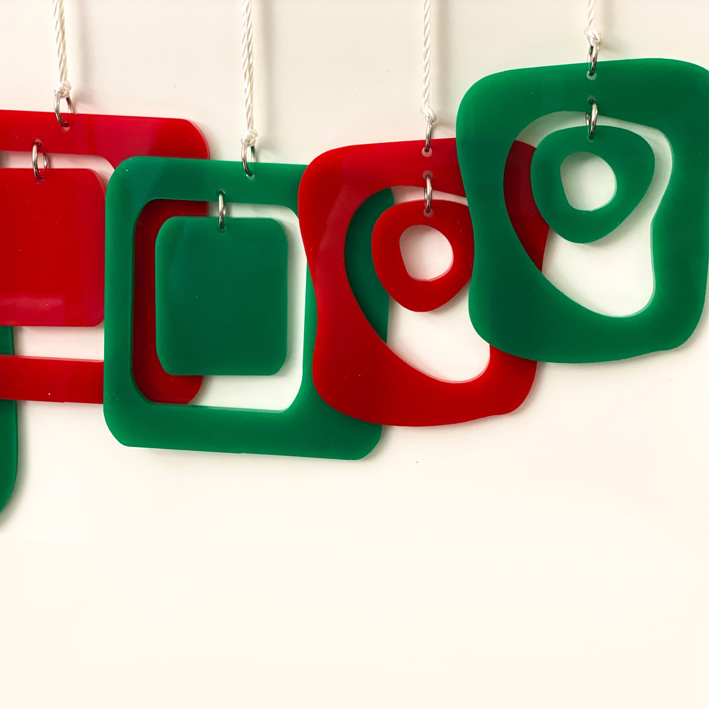 Closeup of beautiful mid century modern style Christmas Ornaments in red and green by AtomicMobiles.com