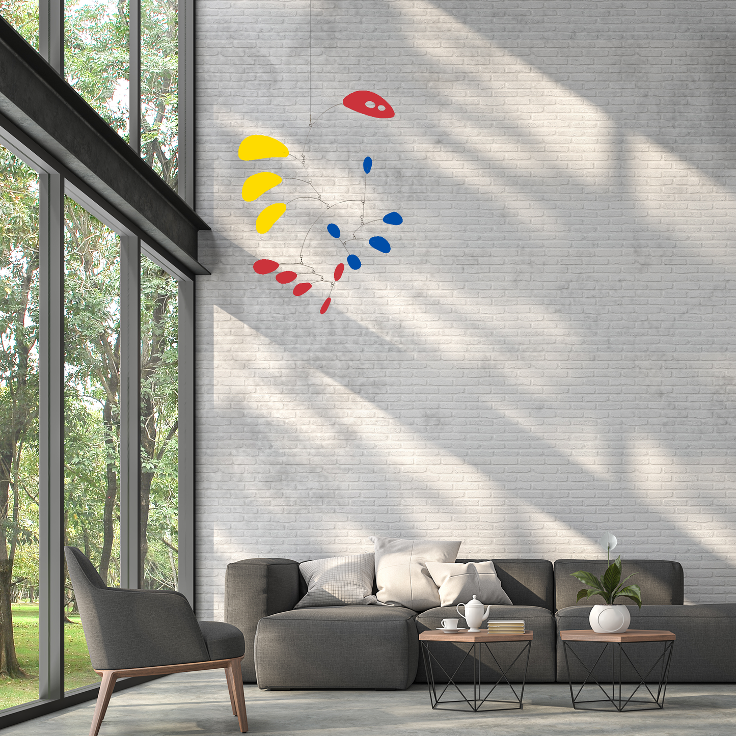 Gorgeous mid century modern CoolCat kinetic art mobile sculpture in Red, Blue, and Yellow, hanging in gray living room with tall ceiling by AtomicMobiles.com