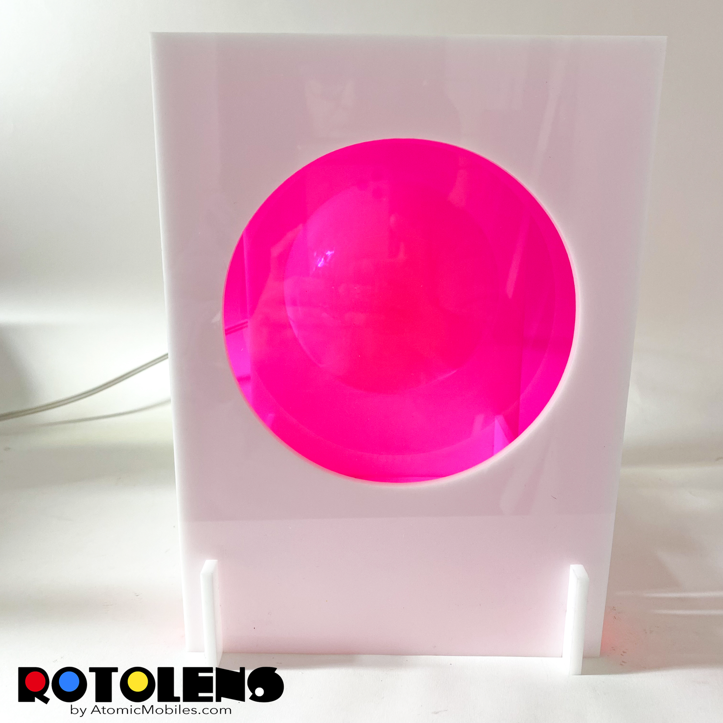 Front view of ROTOLENS Space Age Lamp with interchangeable clear plexiglass lens in Fluorescent Hot Pink by AtomicMobiles.com