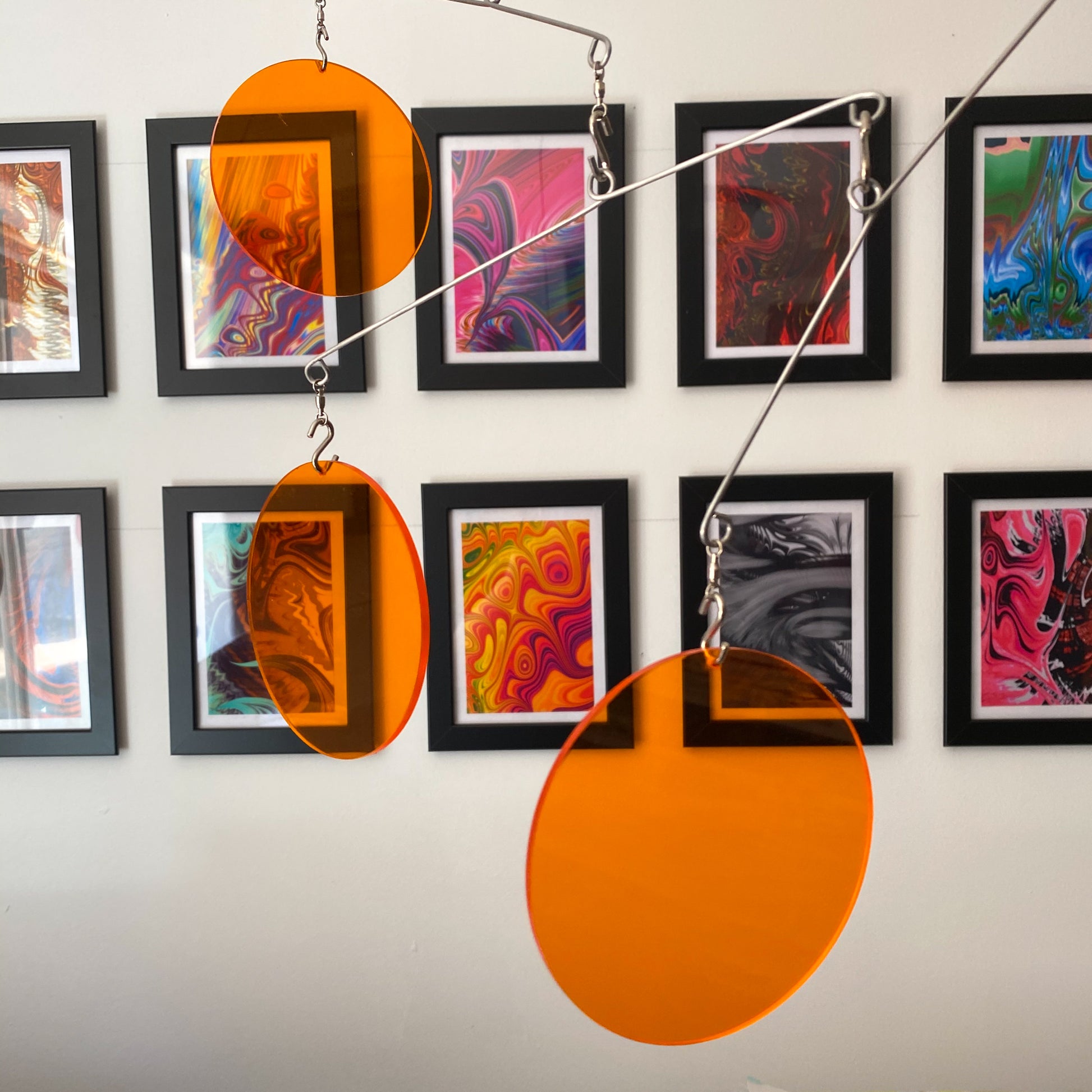 Clear Orange Acrylic Atomic Mobiles in front of MiniMOD abstract colorful art prints by AtomicMobiles.com