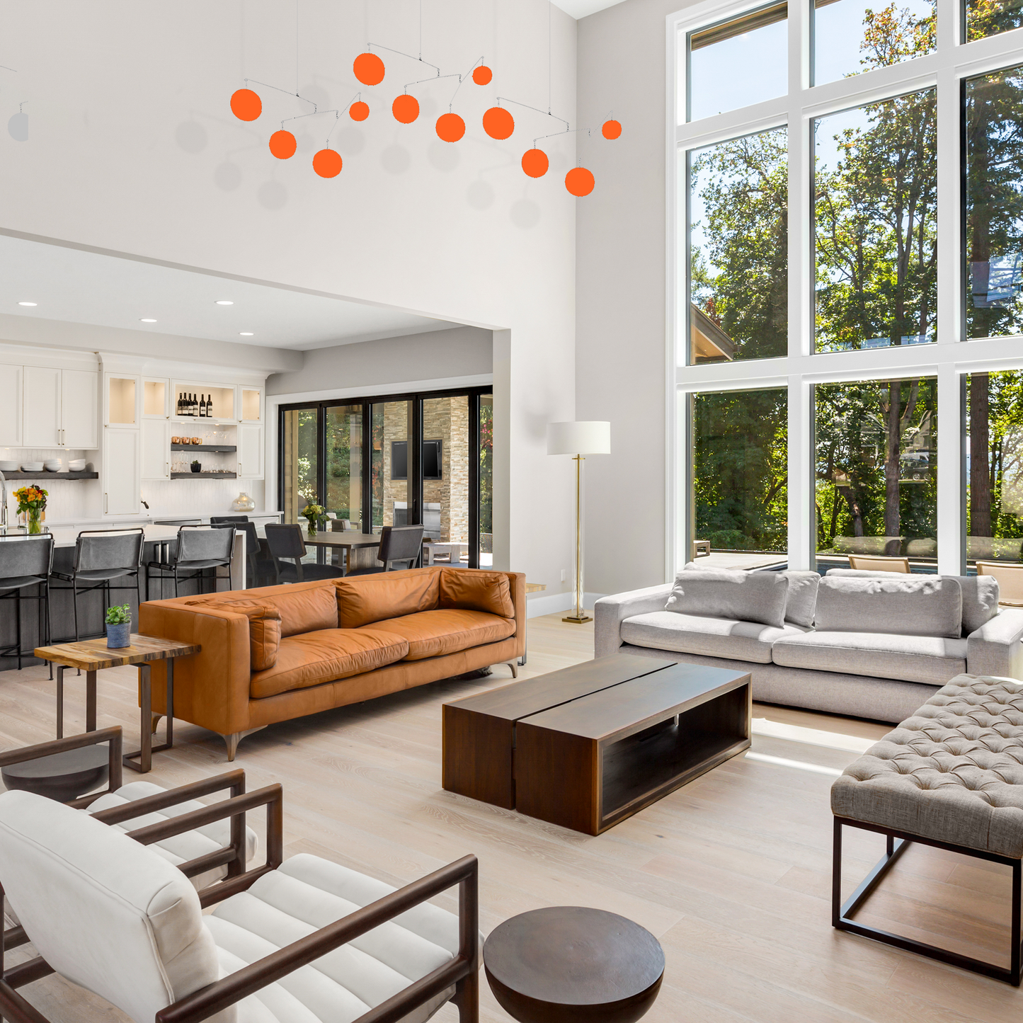 Contemporary living room with tall windows and ceiling feature orange Jetsetter XL hanging kinetic art mobiles by AtomicMobiles.com