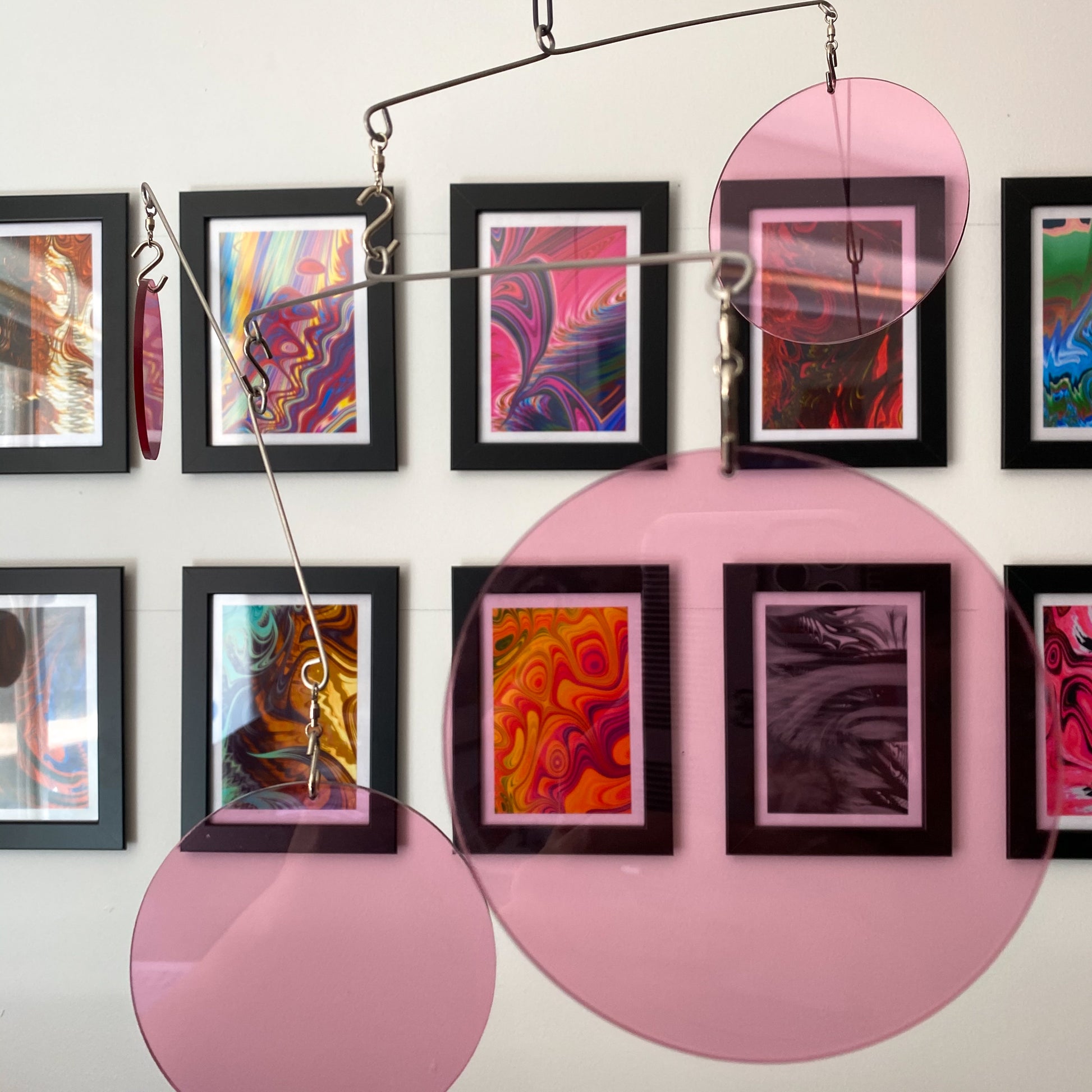 Clear Pink Acrylic Atomic Mobiles in front of MiniMOD abstract colorful art prints by AtomicMobiles.com