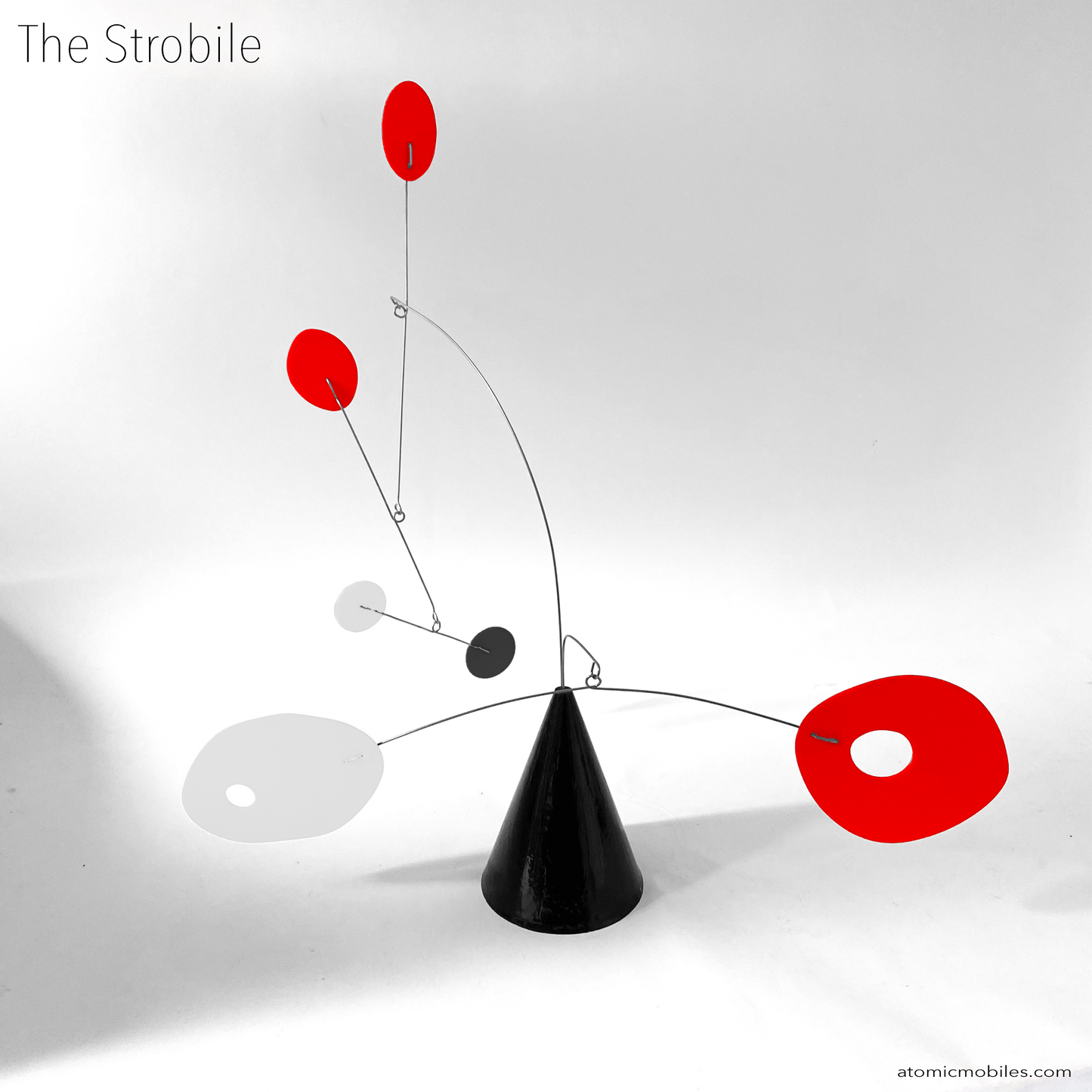 The Strobile table top kinetic art sculpture in red, black, and white by AtomicMobiles.com