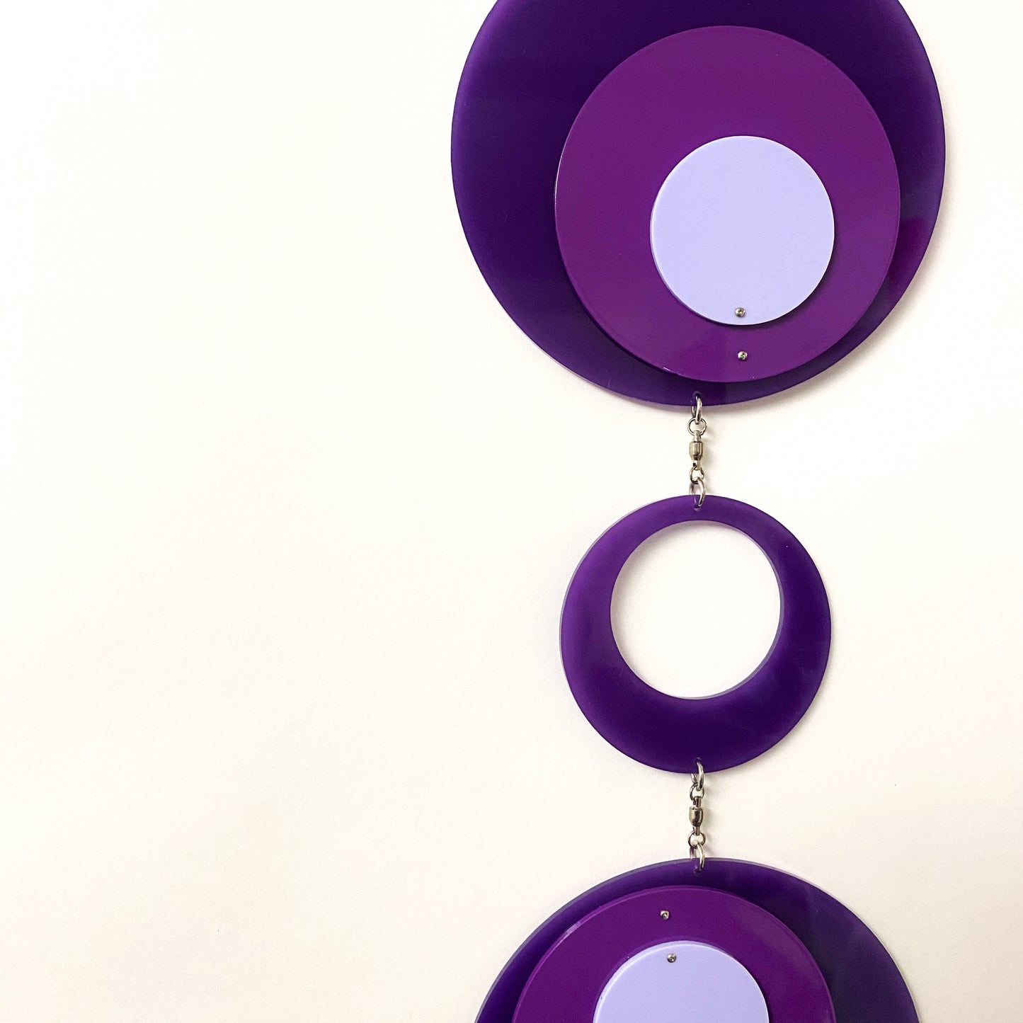 Closeup of Retro 1970s vertical kinetic art mobile in purple circle DOTS ready to ship today by AtomicMobiles.com