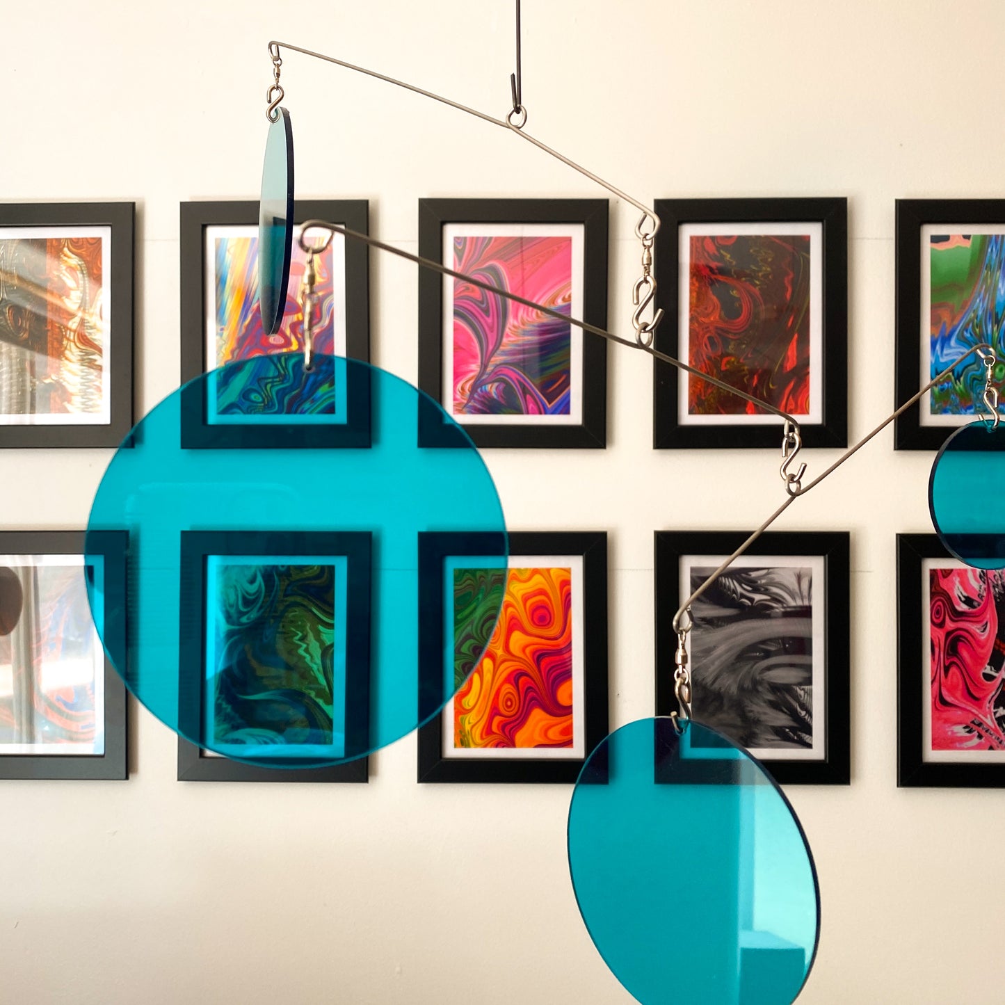 Clear Teal Acrylic Atomic Mobiles in front of MiniMOD abstract colorful art prints by AtomicMobiles.com