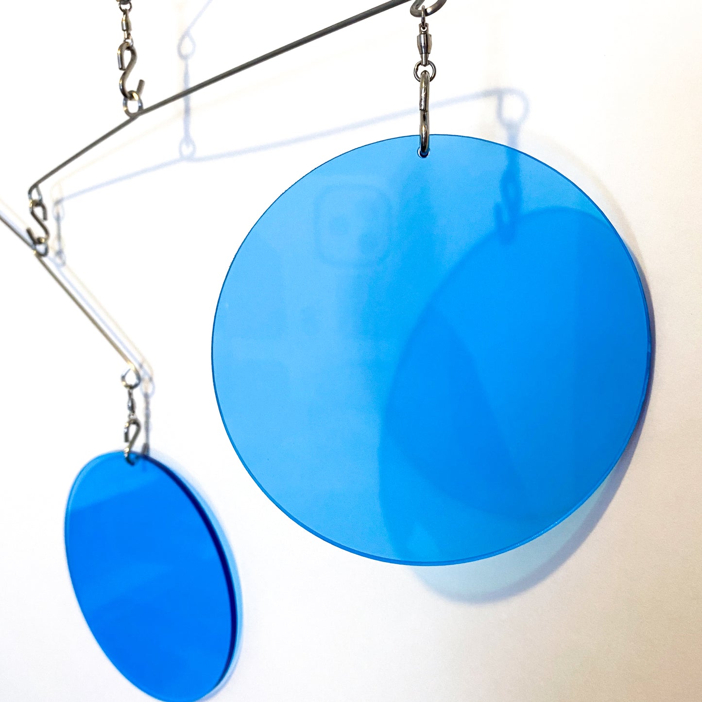 Closeup of Clear Blue Acrylic Atomic Mobile - kinetic hanging art mobiles for modern home decor by AtomicMobiles.com