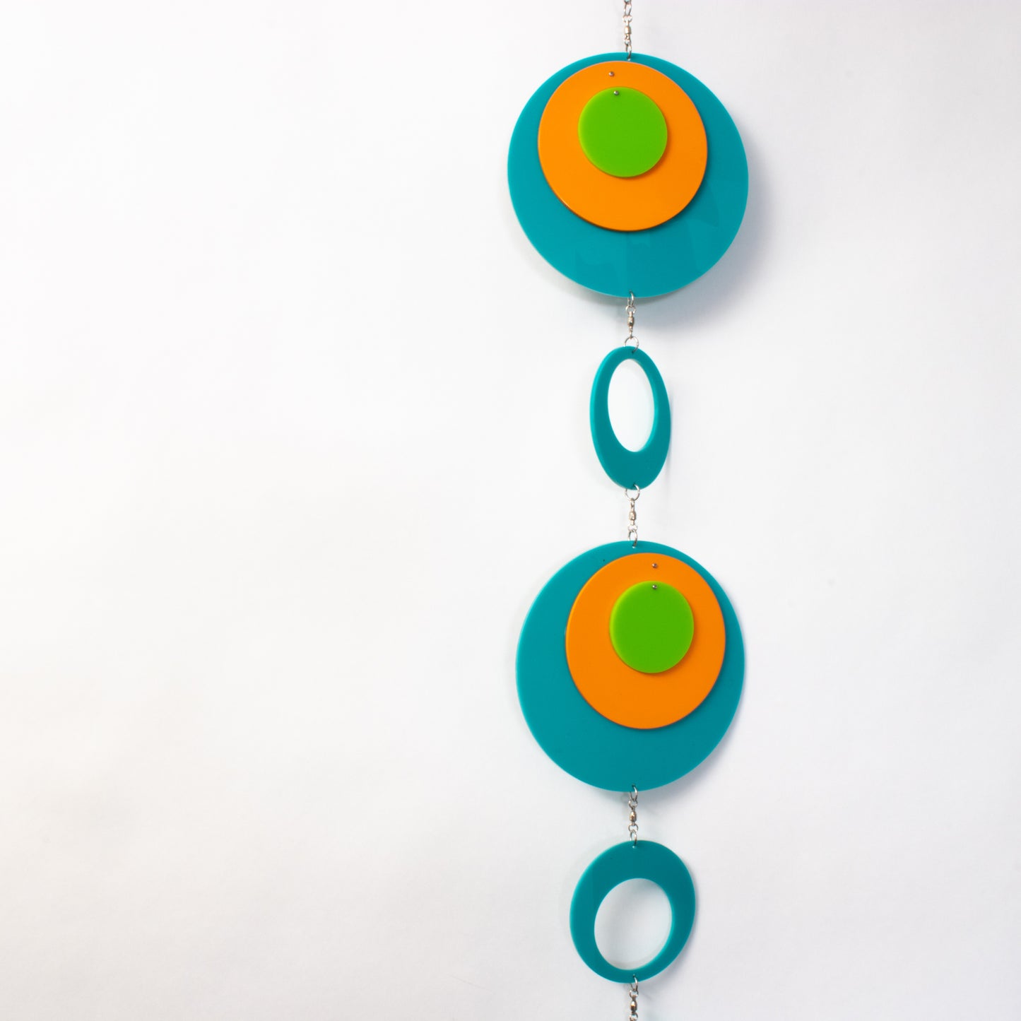 View of beautiful Palm Springs Wall Art Mobile in Aqua Blue, Orange, and Lime Green by AtomicMobiles.com