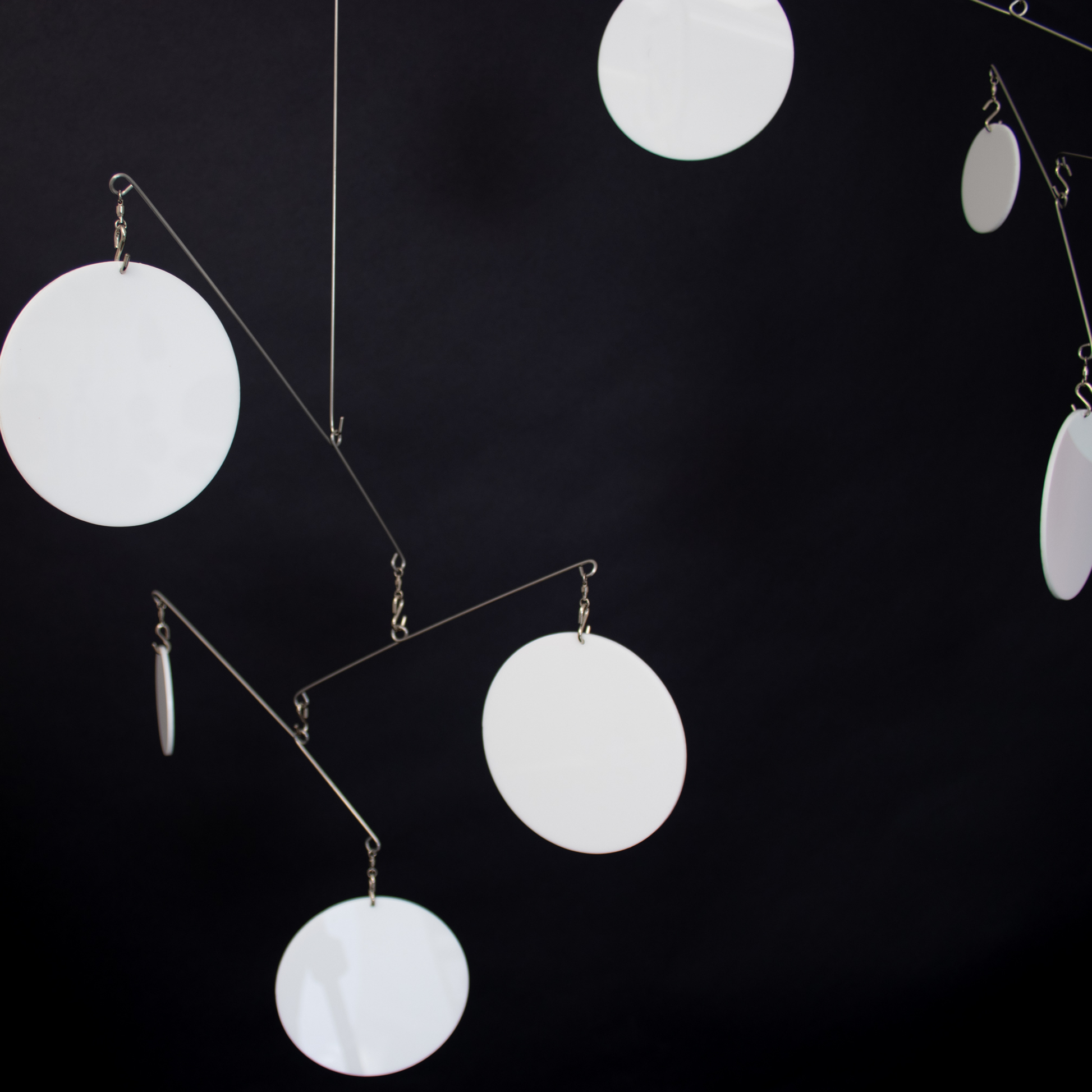 White Atomic Mobiles on black background - DIY Kits for hanging art mobiles in Mid Century Modern Style by AtomicMobiles.com