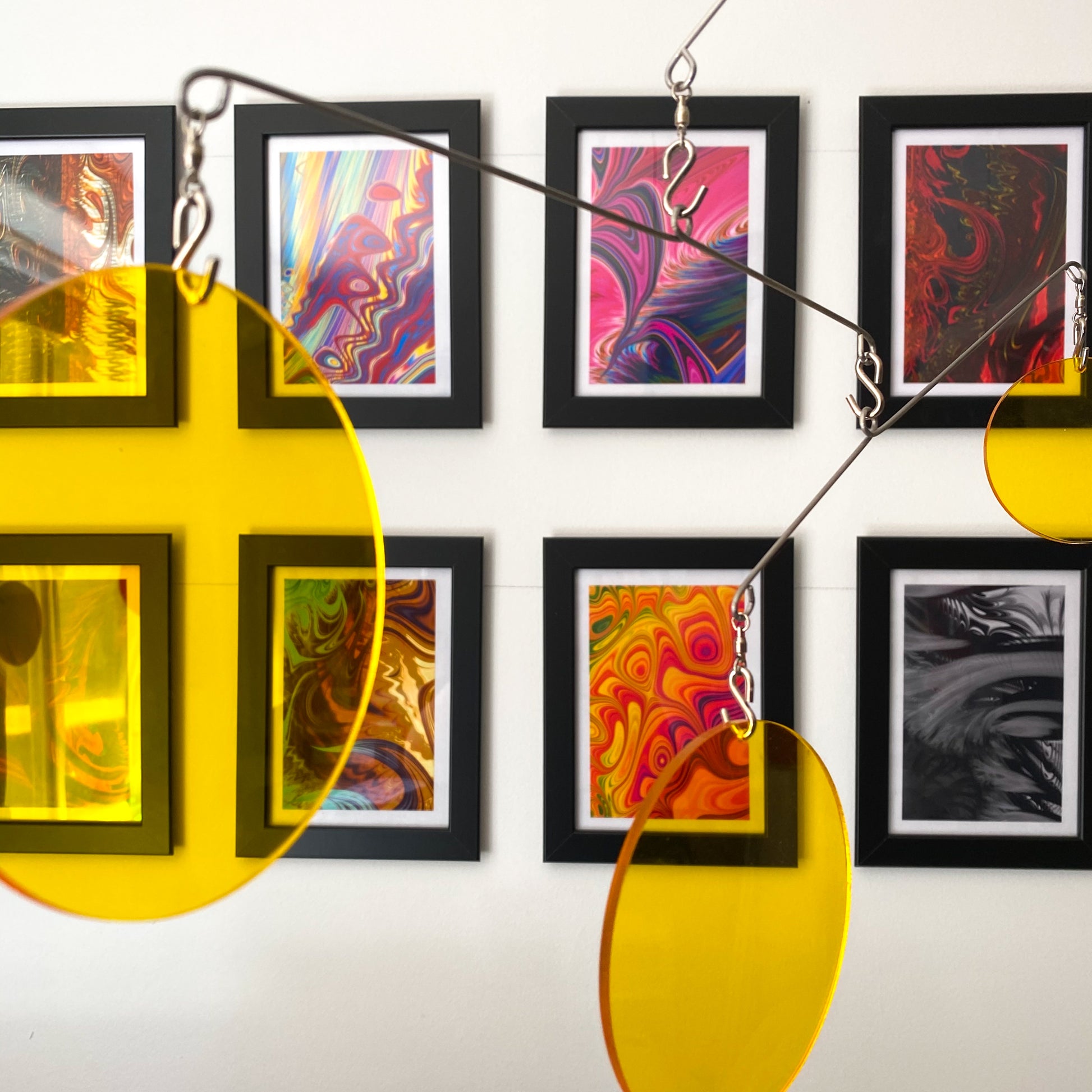 Clear Yellow Acrylic Atomic Mobiles in front of MiniMOD abstract colorful art prints by AtomicMobiles.com